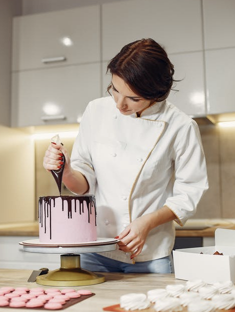 confectioner preparing a cake.